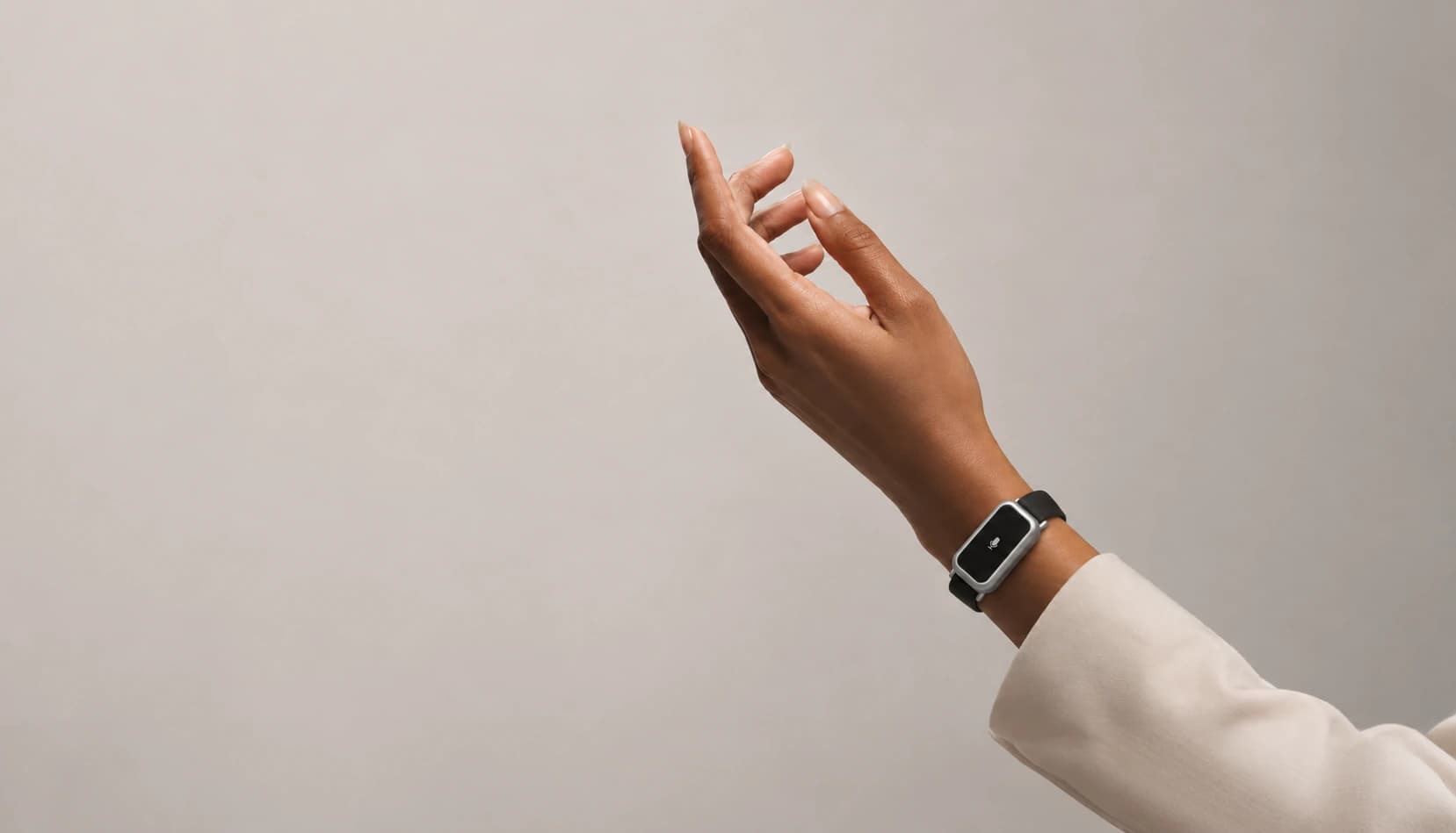 A raised hand wearing Sonal on the wrist, its microphone indicator lit