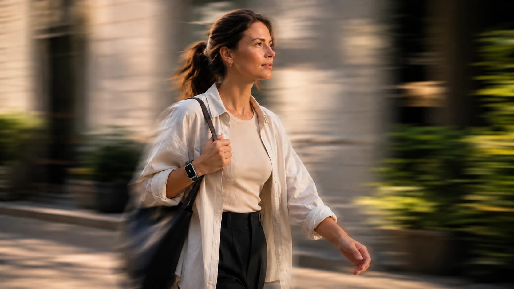 Woman walking by the water wearing Sonal on her wrist