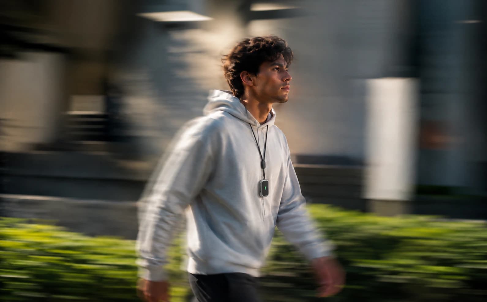 Man walking outside wearing Sonal on a lanyard